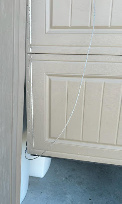 Garage door off the tracks with snapped cable