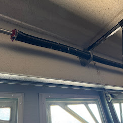Heavy-duty torsion spring system above garage door